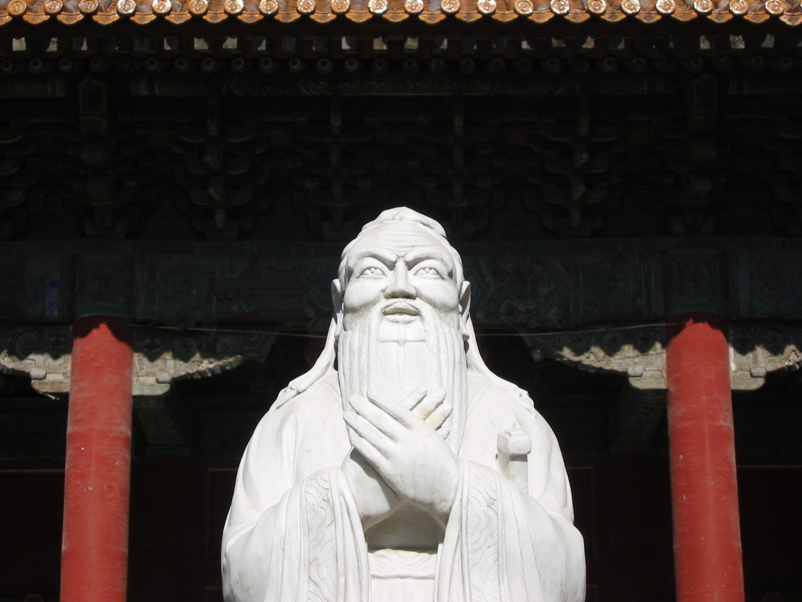 White marble statue of Confucius with clasped hands at the Confucian Temple in Beijing
