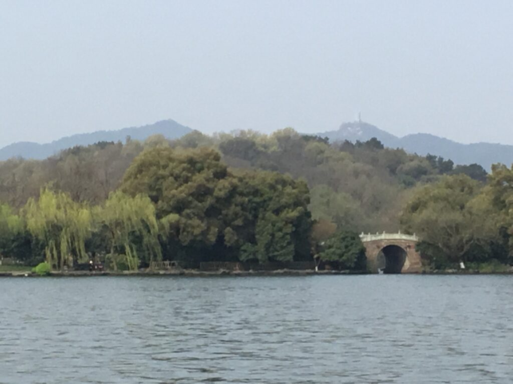 West Lake in Hangzhou seen from the shore with hills beyond