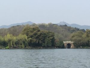 West Lake in Hangzhou seen from the shore with hills beyond