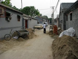 Narrow hutong alley with traditional courtyard houses in Beijing