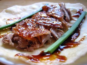 Peking duck wrap with crispy skin, scallion, and sauce