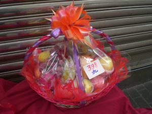 Assorted fruit gift basket wrapped for a Chinese holiday