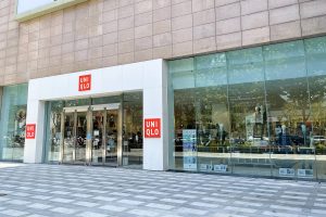 Clothing store interior in a Chinese shopping mall with racks of autumn and winter garments