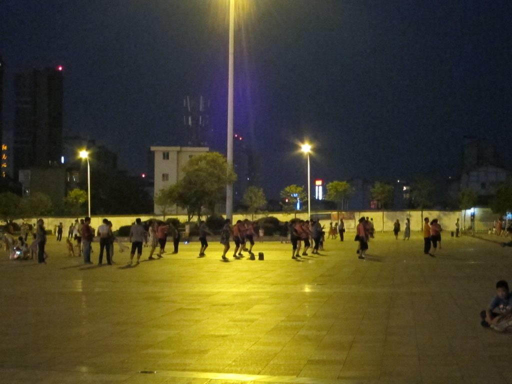 Evening square dancing group in a Chinese urban park
