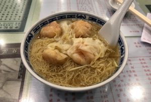 Bowl of Cantonese wonton noodles with clear broth