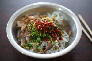 Bowl of Guilin rice noodles (mifen) with toppings and broth