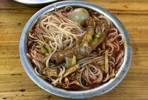 Bowl of Liuzhou luosifen snail rice noodles with toppings
