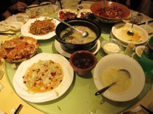 Chinese restaurant table setting with shared dishes on a lazy Susan turntable.