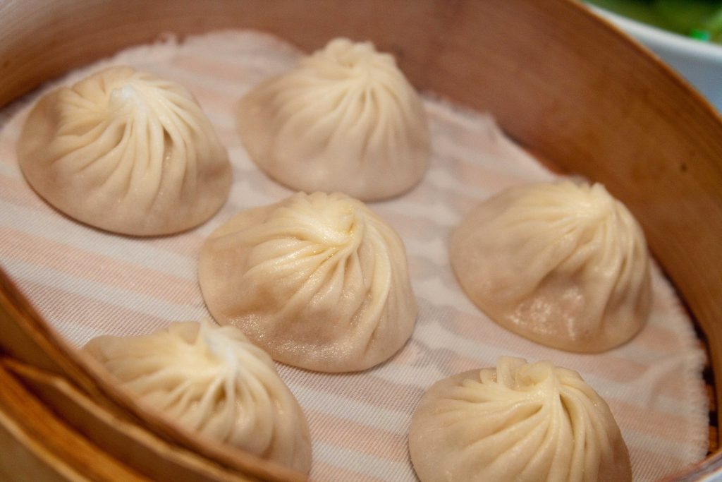 Soup dumplings in a bamboo steamer basket