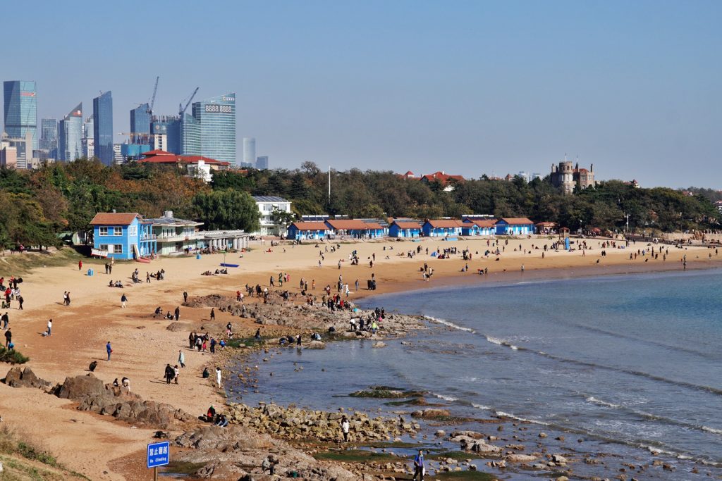 Qingdao Beach No. 2 with sand, sea, and city skyline in the background