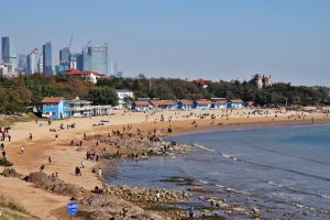 Qingdao Beach No. 2 with sand, sea, and city skyline in the background