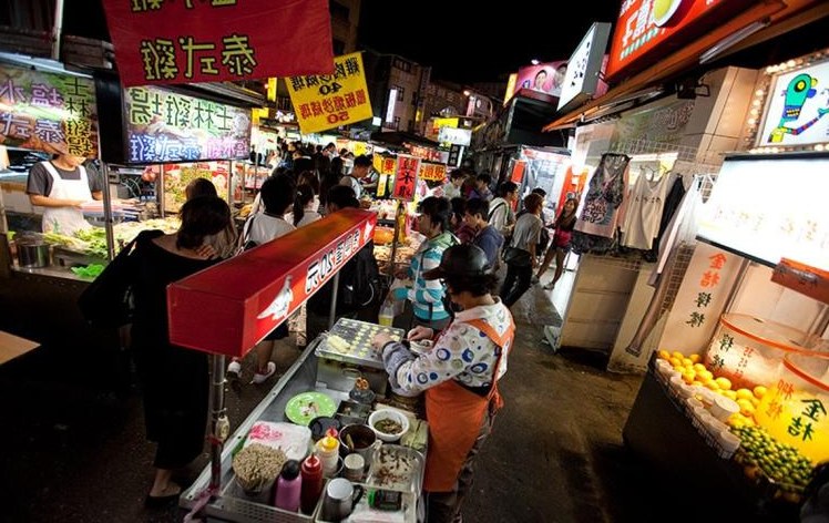 Busy Shilin Night Market food stalls and neon signs in Taipei