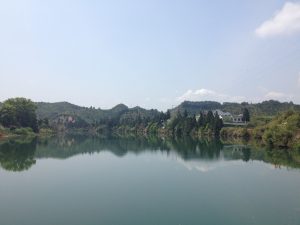 Traditional white-walled village houses among green hills in Wuyuan countryside, Jiangxi