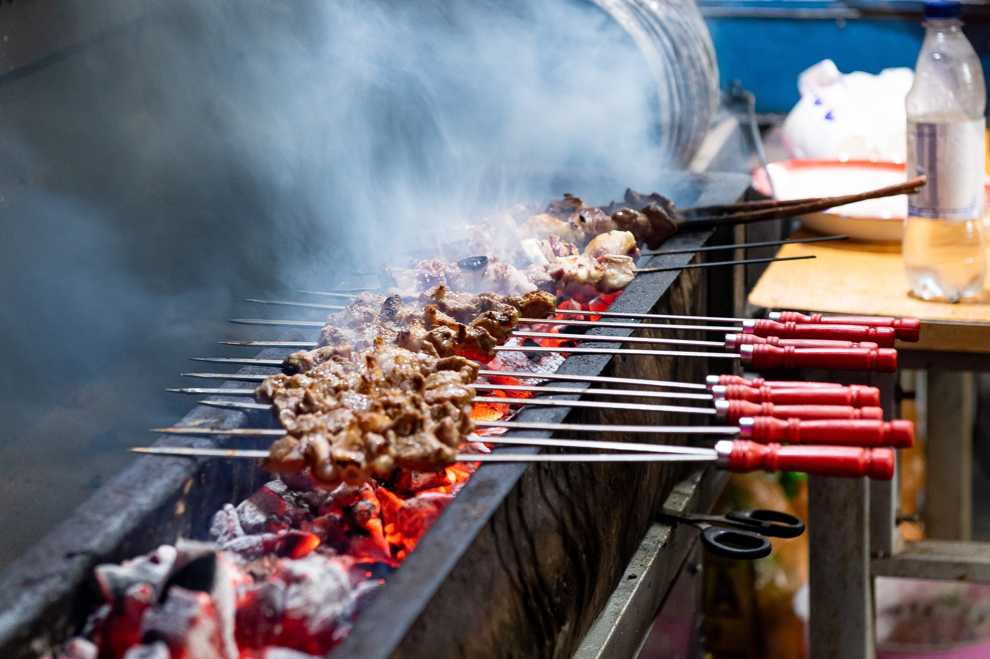 Lamb kebabs grilling over charcoal at a street stall in Kashgar, Xinjiang
