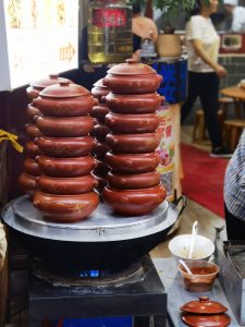 Yunnan steam-pot chicken served in a ceramic qi guo pot